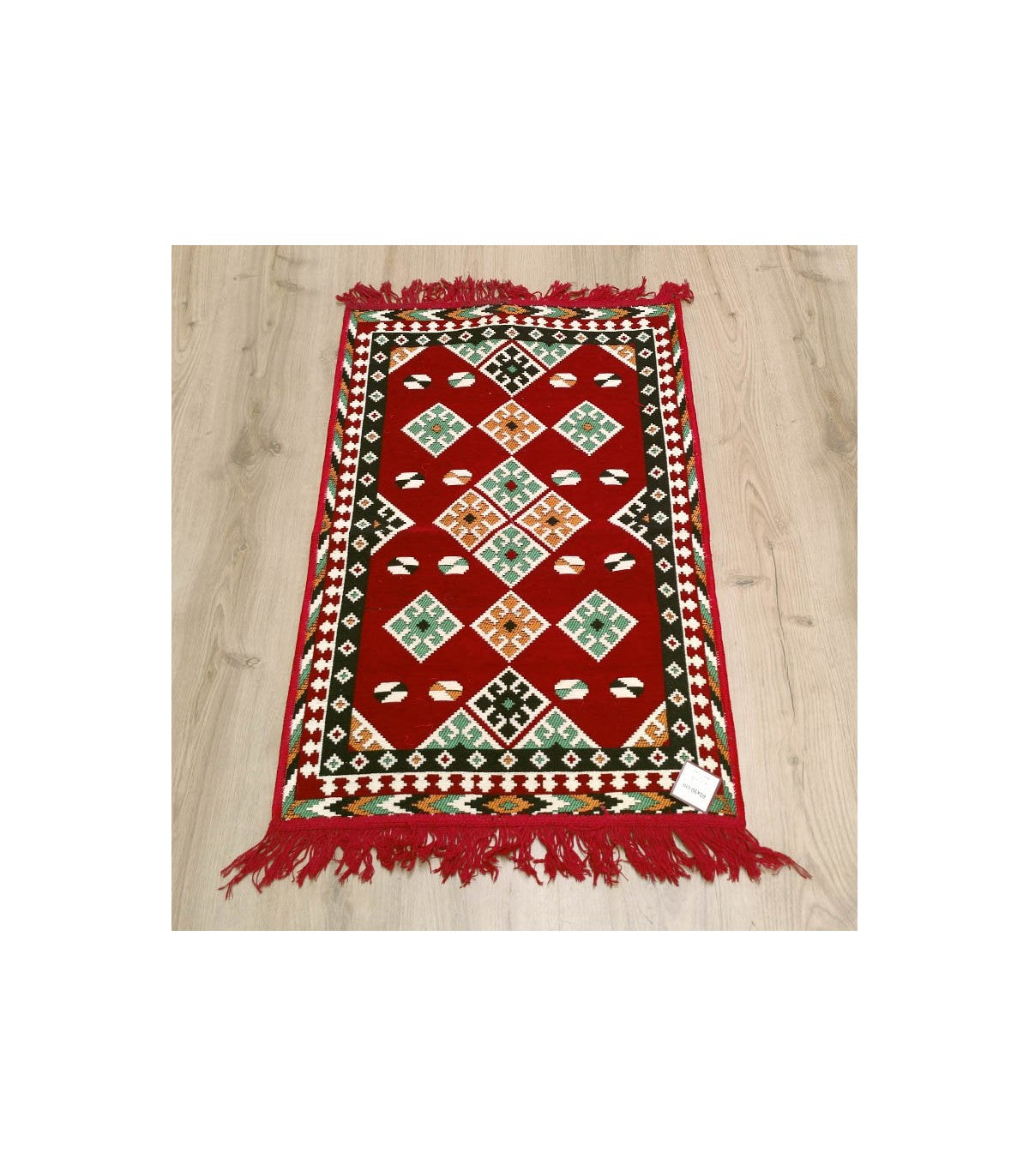 Alfombra tapiz turca kilim 60x90 cm roja mostrando el segundo lado reversible con motivos orientales